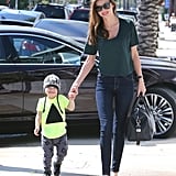 Miranda Kerr made jeans and a t-shirt look chicer than your average casual combo by sticking to dark, skinny denim and finishing with a luxe satchel and classic ballet flats. Like mom, like son — Flynn looked adorable in a beanie and a neon tee at her side.