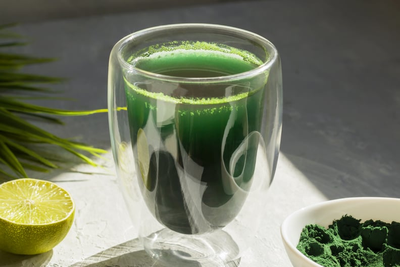 glass of green powder supplement with lime