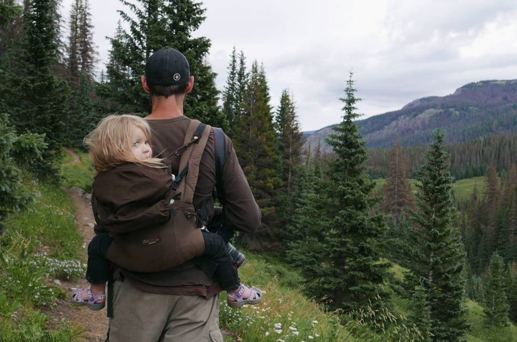 Hiking is so much better when dad carries you.