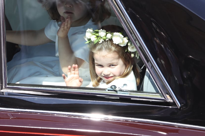 WINDSOR, ENGLAND - MAY 19:  Princess Charlotte waves to the crowd as she rides in a car to the wedding of Prince Harry and Meghan Markle at St George's Chapel in Windsor Castle on May 19, 2018 in Windsor, England.  (Photo by Andrew Milligan - WPA/Getty Im