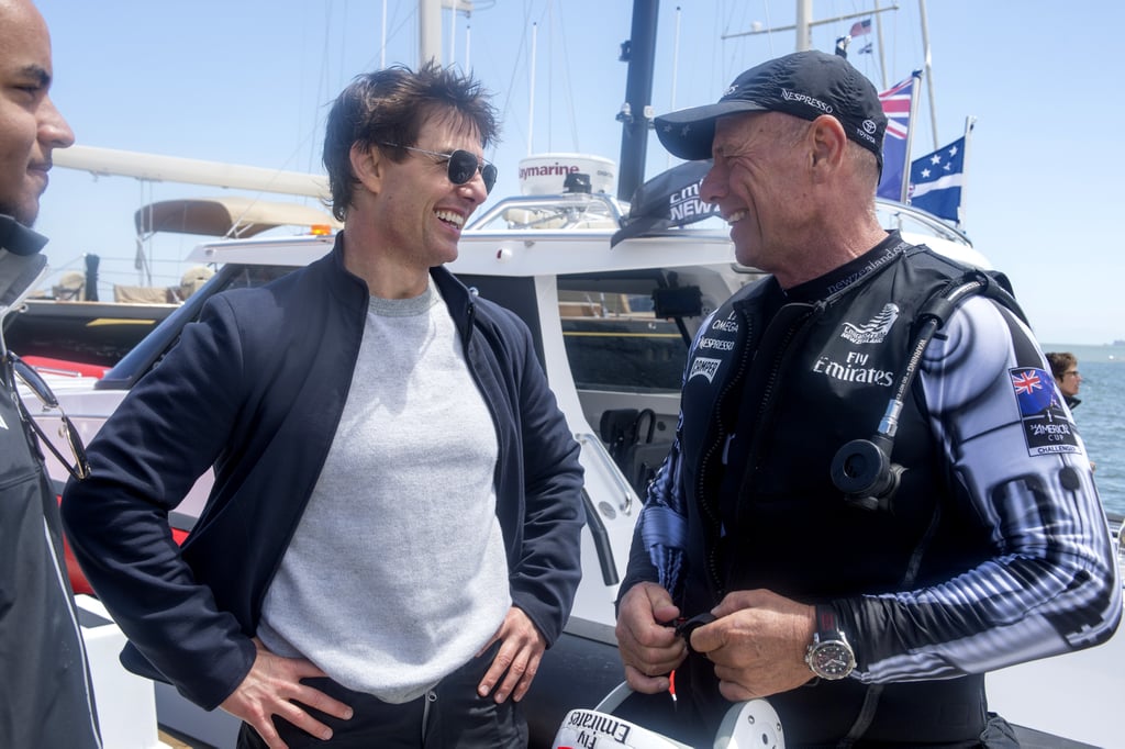 Tom inadvertently showed off a signature pose while chatting with a member of Emirates Team New Zealand before he set sail in San Francisco.