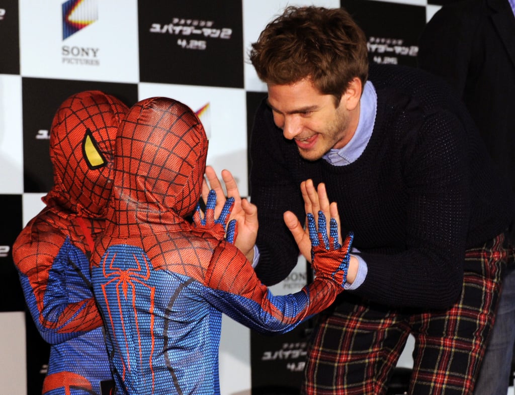 Andrew high-fived two tiny Spider-Man fans at an event in Tokyo in March 2014.