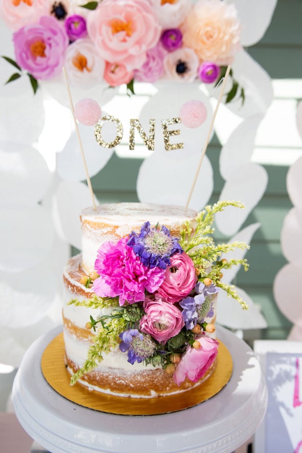 Don’t forget about the cake for this birthday girl! Created by Sprinkle and Dash, it was a gorgeous simple, yet tasty cake that fit in with the garden party theme beautifully. The cake topper was made by Little Dovie and was so fitting for this little girl’s Number One birthday! We love this simple idea that has been a big trend item right now!