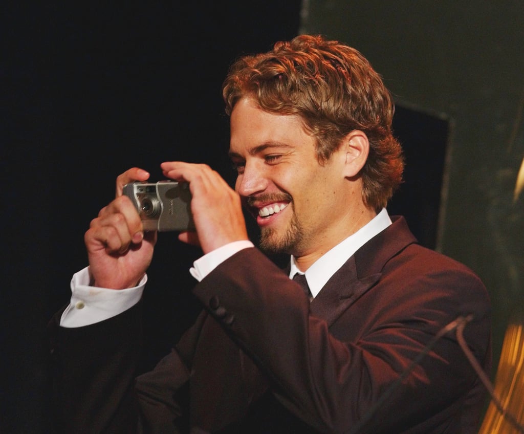 He smiled while snapping photos at the Hollywood Film Festival Awards in August 2001.