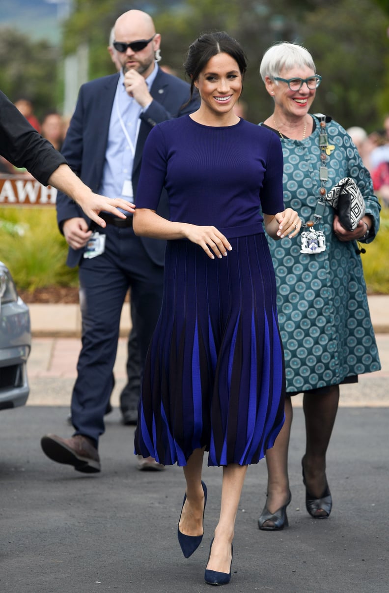 Meghan in a Navy Sweater and Pleated Skirt