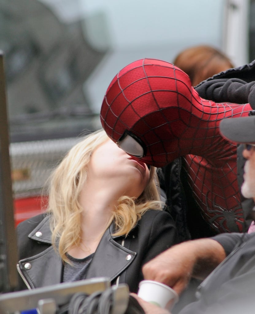 Sporting his Spider-Man costume, Andrew gave Emma a kiss during a break from filming in NYC in May 2013.