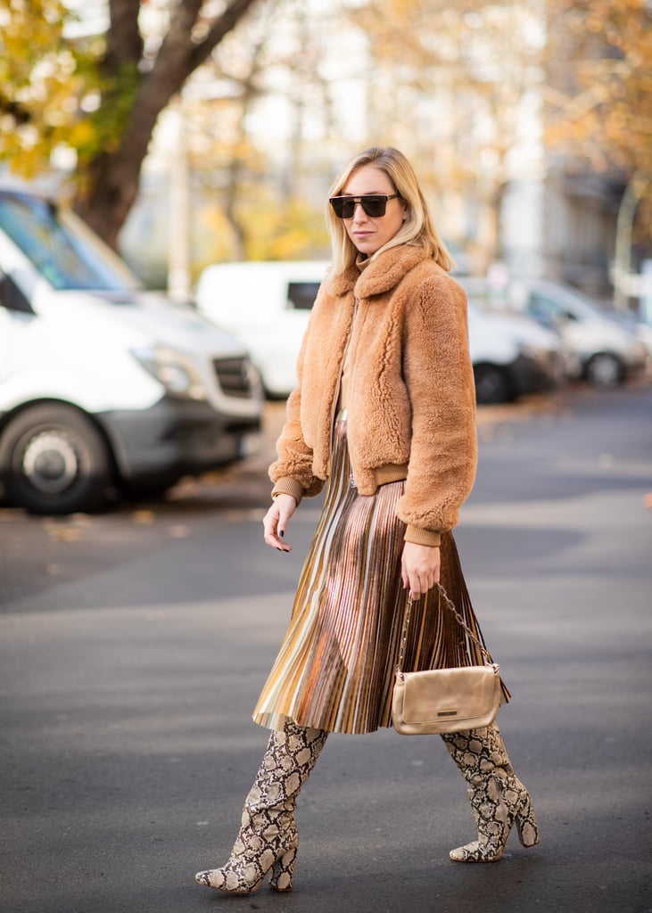 Style neutral separates like a cropped shearling jacket and pleated midi skirt with tall snakeskin boots.