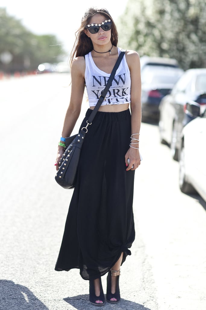 This Coachella party attendee showed off her city cred in black maxi, NYC tank, and tough accessories.