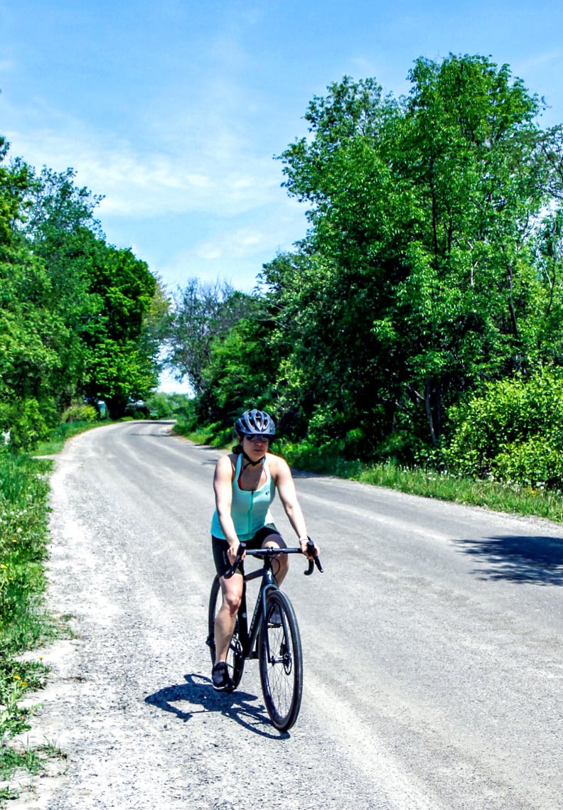 specialized crux expert gravel bike review - woman riding Crux pro down gravel road