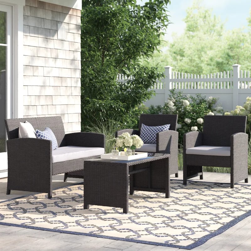 A Patio Set: Lark Manor Ebron Wicker/Rattan 4 Person Seating Group with Cushions
