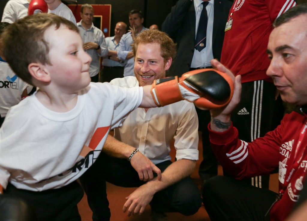 Prince Harry was all smiles as he watched a young boy show off his boxing skills during a visit to the Double Jab Boxing Club in London in June.
