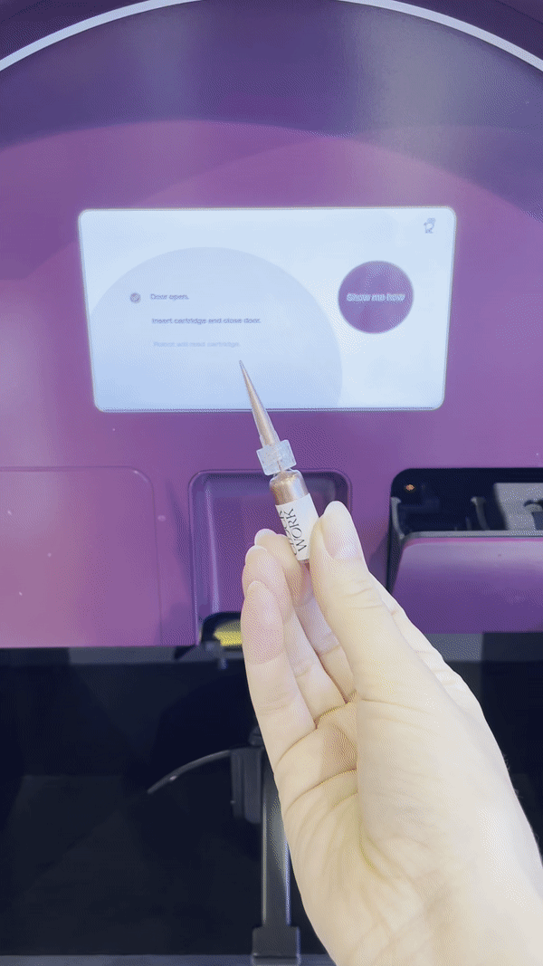 Inserting nail polish into robot machine before painting nails