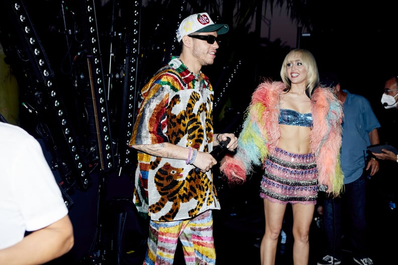 Miley Wore a Dolce & Gabbana Sequined Bra, Miniskirt, and Rainbow Feather Jacket