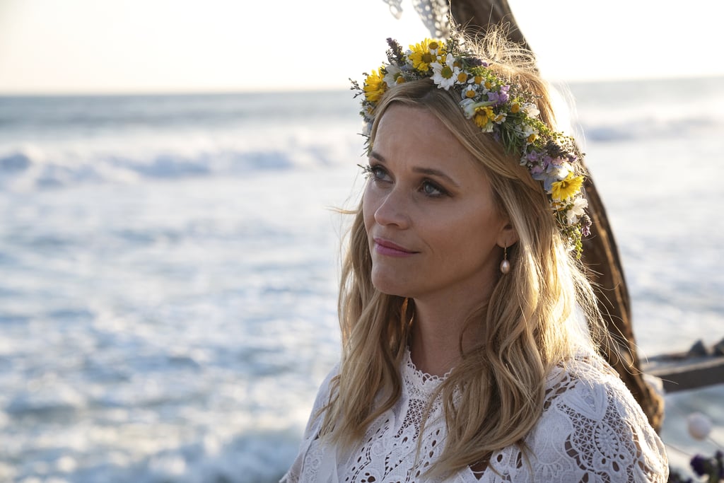 Reese Witherspoon as Madeline Martha Mackenzie in an eyelet lace dress and floral crown.