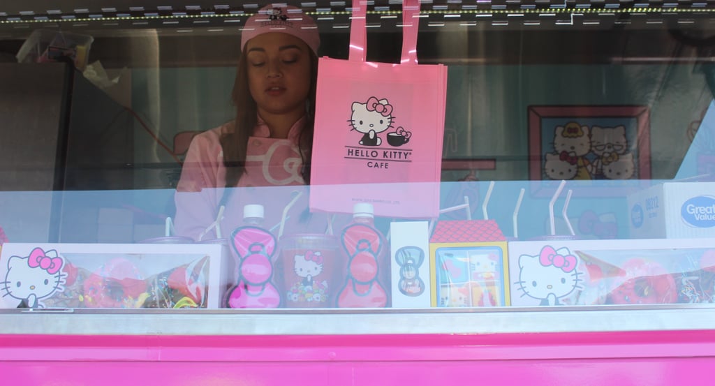 The truck's service counter shows off all the available menu items for customers waiting in line. Employees clad in pastel pink uniforms bustle around within the truck, quickly and efficiently serving the line of kitty-obsessed patrons.