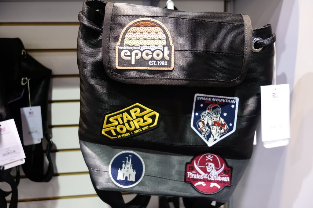 This incredible Harvey's seat belt backpack — a D23 Expo exclusive — was affixed with retro Epcot patches and nods to famed Disneyland attractions.