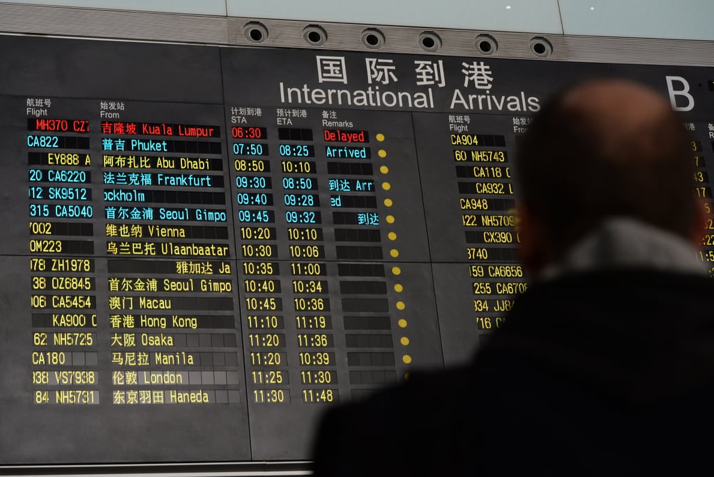On Saturday, a man looked up at the arrival board at Beijing Capital International Airport, where the flight was expected to land.