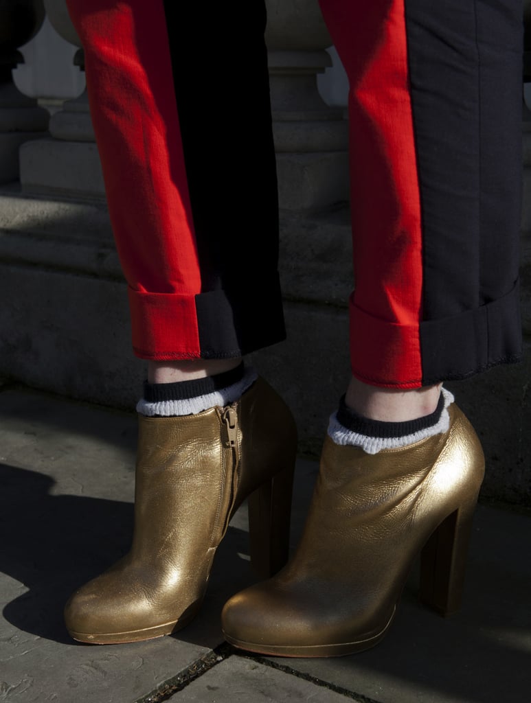 Gold ankle boots and red trousers stood out against the street-style crowd.
Gold ankle boots and red trousers stood out against the street-style crowd.