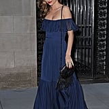Miranda Kerr was feminine as ever in an off-the-shoulder navy maxi dress while out in NYC. She added a black fringe bag and blue t-strap sandals to her mix to complete her look.