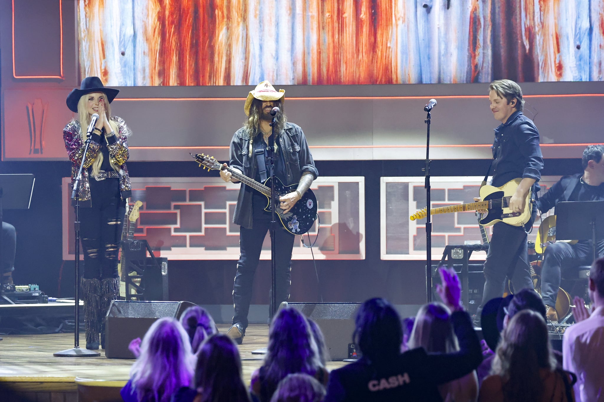 NASHVILLE, TENNESSEE - AUGUST 23: (L-R) FIREROSE, Billy Ray Cyrus, and Travis Denning perform onstage during the 16th Annual Academy of Country Music Honours  at Ryman Auditorium on August 23, 2023 in Nashville, Tennessee. (Photo by Jason Kempin/Getty Images for ACM)