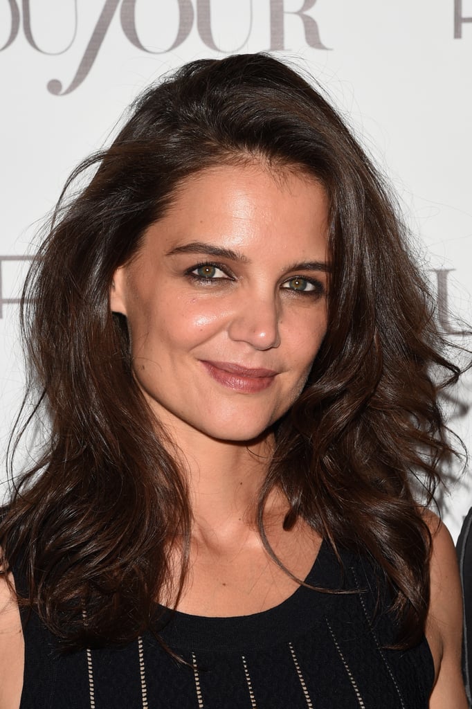POPSUGAR: You’ve worn so many hairstyles through the years: bangs, bobs, long hair, etc. Which one has been your favorite?
Katie Holmes: I love having long hair because of the versatility. And what I love about Alterna’s Caviar shampoo and conditioner is it’s really healthy for your hair and it’s paraben-free — you’re constantly nourishing your hair so that you can grow it long. There’s also the Alterna Caviar Repair Lengthening Hair & Scalp Elixir ($38), which prevents split ends to help to grow it out, too. I prefer it long. 
PS: Do you have a favorite updo or style to wear when it’s long? 
KH: I love a topknot. 
PS: What are three products that you always keep on you when you travel? Hair, makeup, or skin.
KH:  I always keep Alterna Bamboo Smooth Kendi Dry Oil ($25) in my purse because it prevents the frizz. [I also bring] Olay hydrating moisturizer. I moisturize before I take off and when I land from the flight. And then I  usually have a good granola bar. I just got a bunch of Annie’s chocolate chip granola bars. I also Orbit sugar-free gum in spearmint. 
PS: Are you going to celebrate Halloween this year?  
KH:  I am! I’m going to increase the color palette. I don’t know, I have to talk to Dotti
 about my makeup for Halloween. 
PS: Are you planning on dressing up? 
KH:  Maybe! I never decide until the last minute. But I’m gonna find some homemade candy bars and wrap them in ribbon.