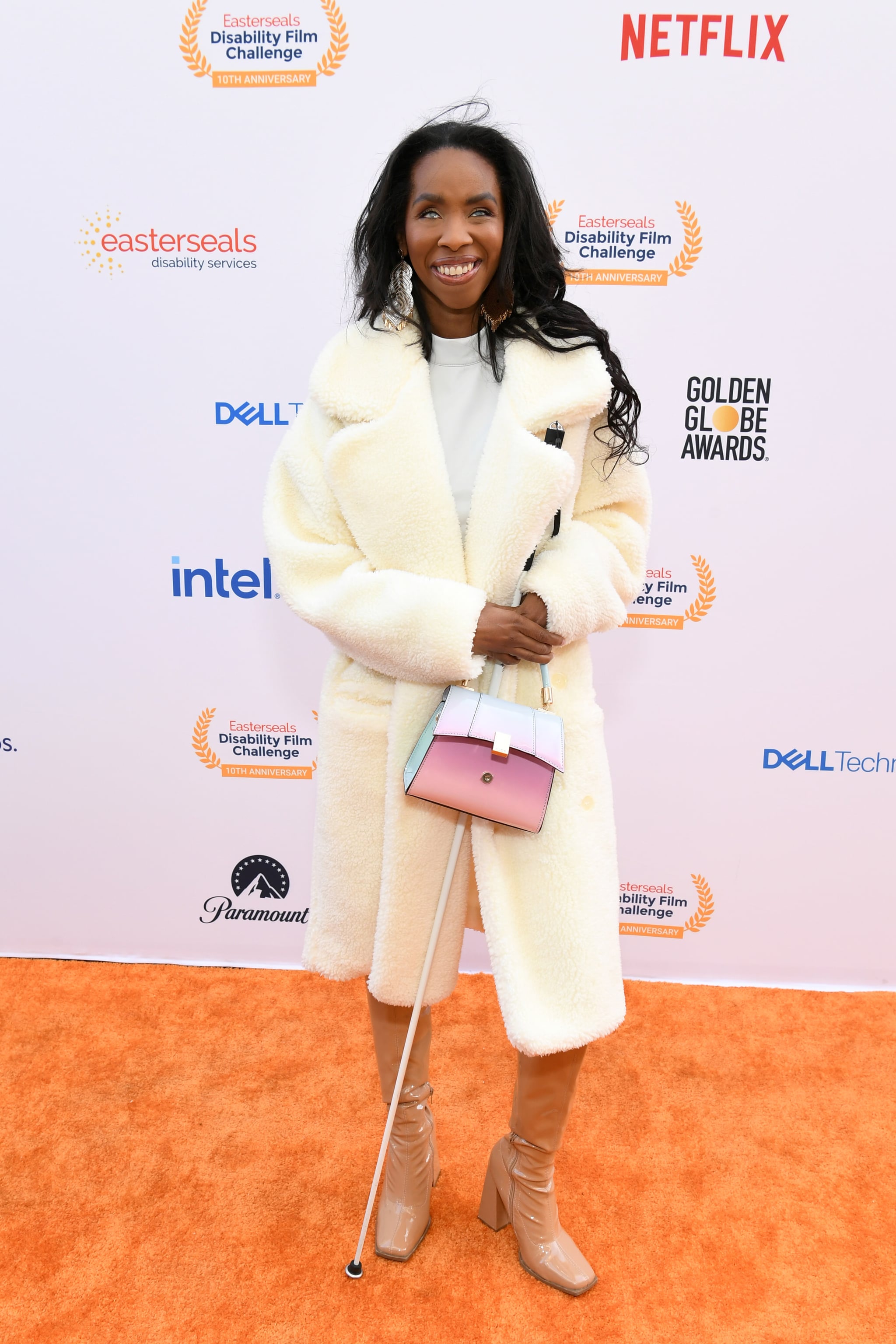 Natalie Trevonne attends the 10th Annual Easterseals Disability Film Challenge at Sony Pictures Studios on May 04, 2023, in Culver City, California. Her full body is pictured as she wears a fur coat, tan shoes, and poses with a purse and cane.