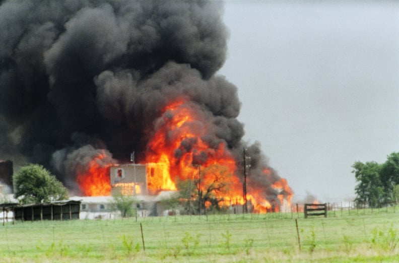 The Branch Davidian cult compound observation tower in Waco, TX is engulfed in flames after a fire burns the complex to the ground 19 April 1993. (Photo by TIM ROBERTS / AFP) (Photo by TIM ROBERTS/AFP via Getty Images)
