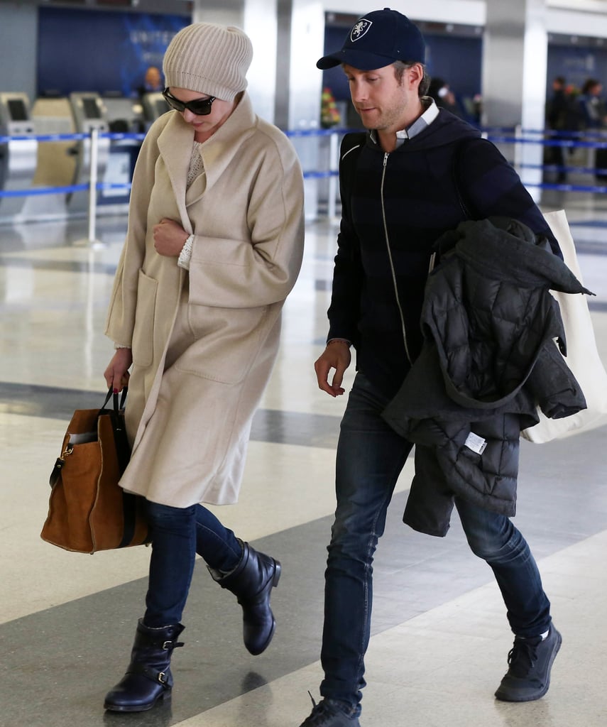 Anne Hathaway and her husband must have been jetting to somewhere chilly — she was super bundled up in an oatmeal topper, beanie, and fur-lined moto boots.