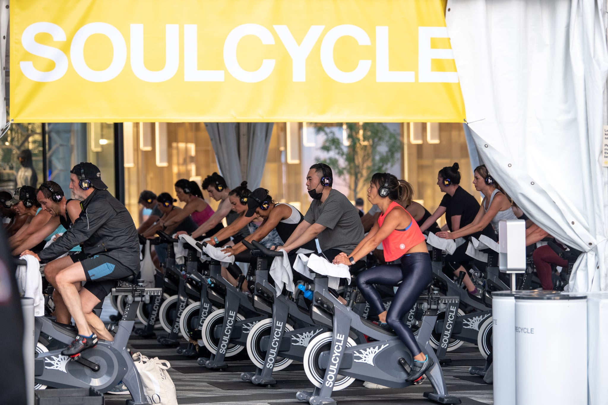 NEW YORK, NEW YORK - SEPTEMBER 24: A man wearing a pulled down mask attends a Soulcycle spin class at the Backyard in Hudson Yards as the city continues Phase 4 of re-opening following restrictions imposed to slow the spread of coronavirus on September 24, 2020 in New York City. The fourth phase allows outdoor arts and entertainment, sporting events without fans and media production.  (Photo by Alexi Rosenfeld/Getty Images)