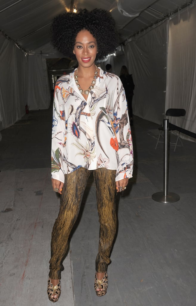 Solange styled her gold-and-black leggings with a floral button-down blouse and cutout leopard sandals during NYFW Spring 2012.