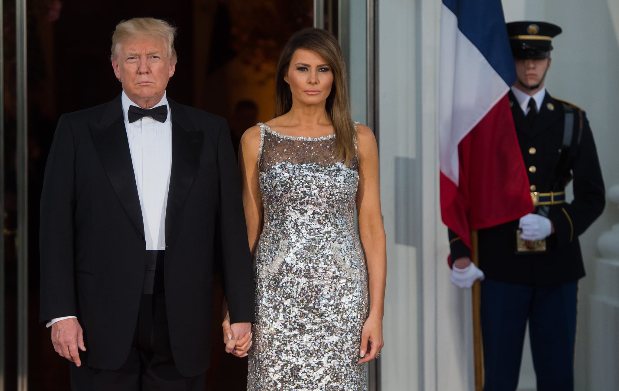 TOPSHOT - US President Donald Trump and First Lady Melania Trump welcome French President Emmanuel Macron and his wife Brigitte Macron as they arrive for a State Dinner at the North Portico of the White House in Washington, DC, April 24, 2018. (Photo by SAUL LOEB / AFP)        (Photo credit should read SAUL LOEB/AFP/Getty Images)