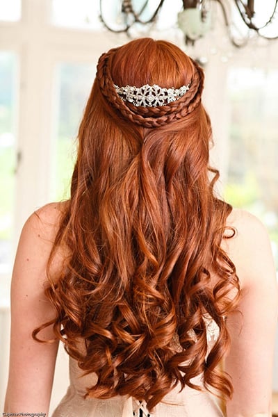 Long and loose tendrils are a must — we love the way the braid frames this bride's tiara.