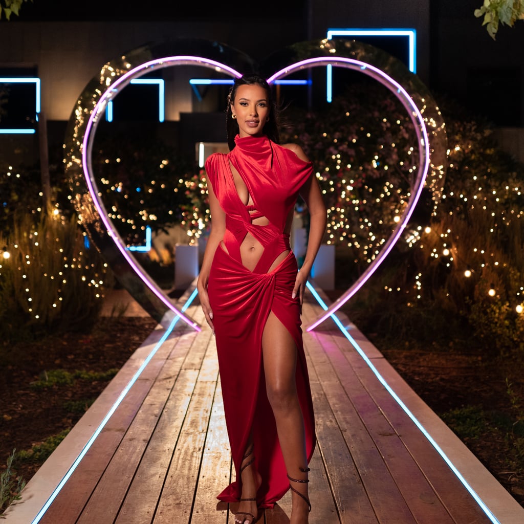 For the Casa Amor recoupling, Jama pulled out all the stops for the occasion. Wearing a red satin cutout body suit by LaQuan Smith (the second time she's worn the designer during the series) with a matching red maxi skirt with thigh-high slit, the presenter certainly turned heads. The bodysuit itself included an asymmetric sleeve, multiple cutout sections, and a backless tie, which was teamed with velvet wrap skirt. She added scultpural heels and sported a half-up hairdo with simple gold hoops.