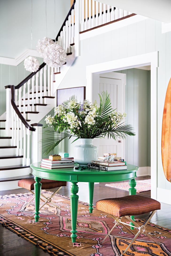 Katie gave her black entryway table a second life by painting it a kelly-green hue, and she reupholstered the X-base benches with fabric brought back from Sri Lanka by her designer friend Nate Berkus.