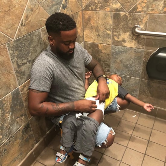 Dad Changes Son's Diaper on His Lap in Public Bathroom