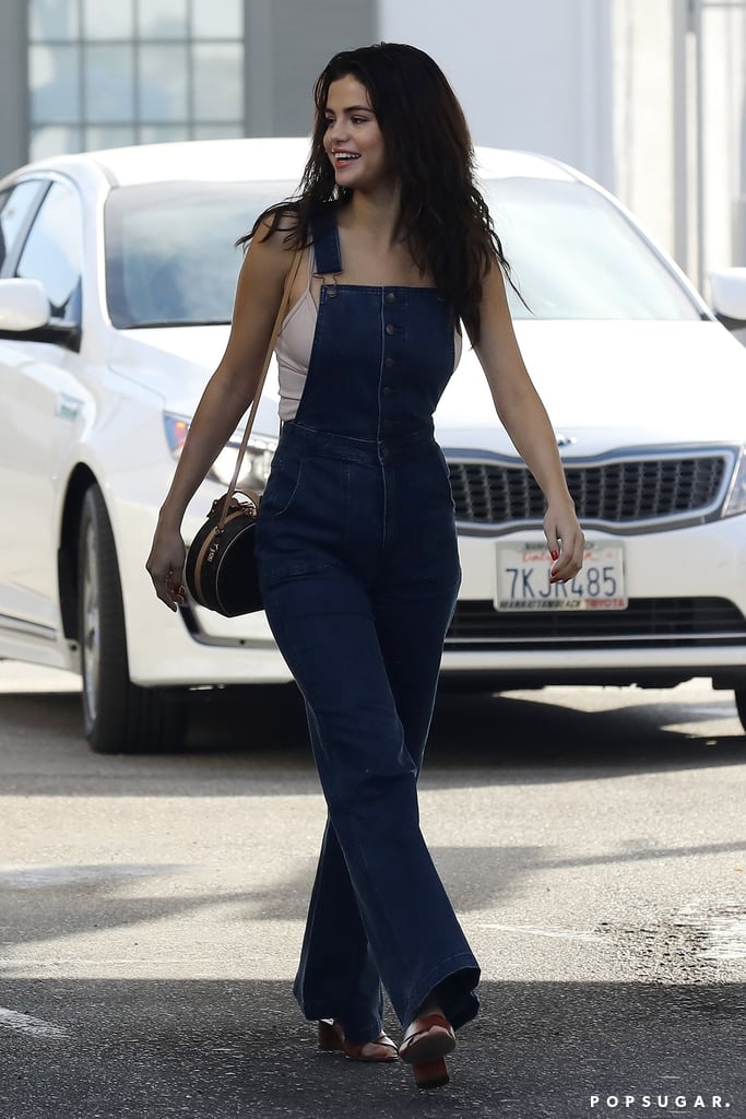 In February, Selena kicked it back to the '70s in her vintage Wrangler overalls. She styled the look with a neutral camisole and cognac, block-heel sandals. The singer completed the look with a Louis Vuitton circle bag.