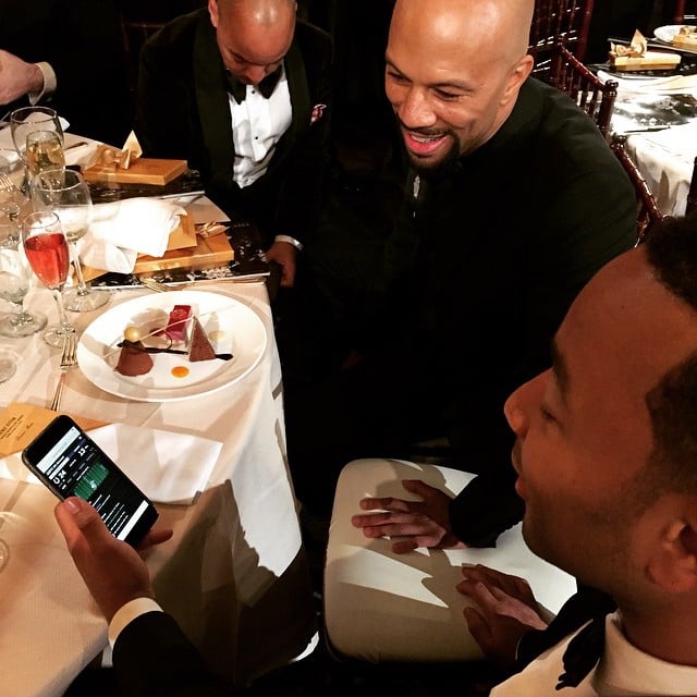 Chrissy Teigen caught John Legend and Common checking on the game.