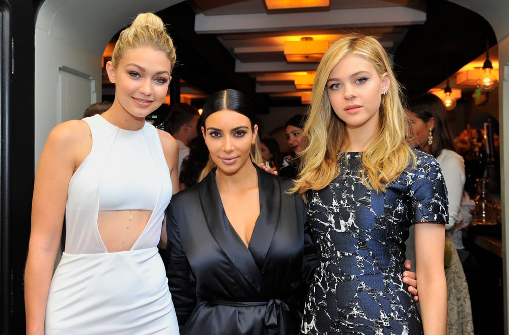 Kim wrapped her arms around model Gigi Hadid and actress Nicola Peltz.