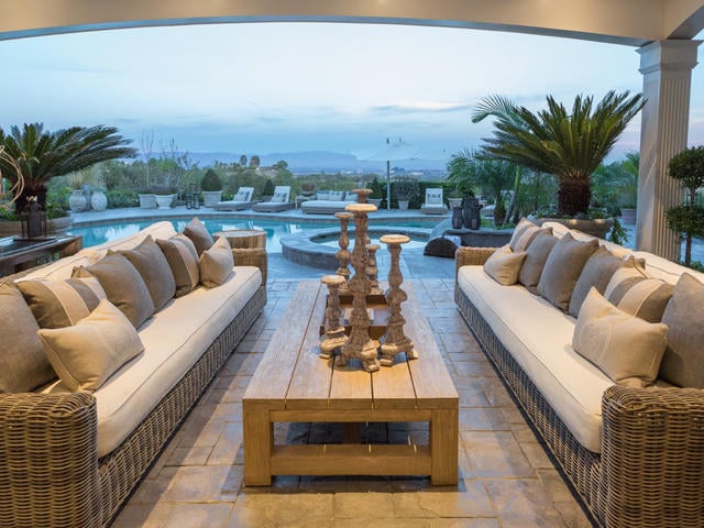 An outdoor kitchen, BBQ grill, and lanai make it easy to dine alfresco.