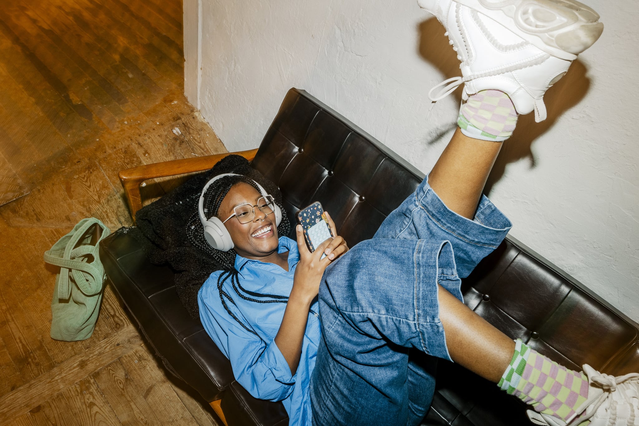 woman wearing headphones on the phone with a friend