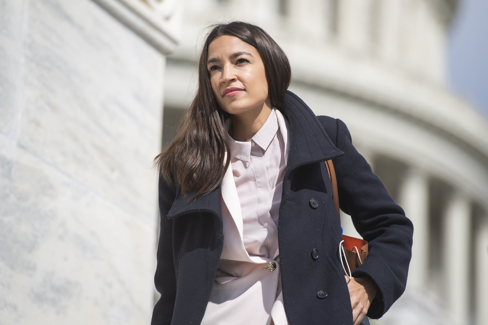 UNITED STATES - MARCH 27: Rep. Alexandria Ocasio-Cortez, D-N.Y., is seen on the House steps of the Capitol before the House passed a $2 trillion coronavirus aid package by voice vote on Friday, March 27, 2020. (Photo By Tom Williams/CQ-Roll Call, Inc via Getty Images)