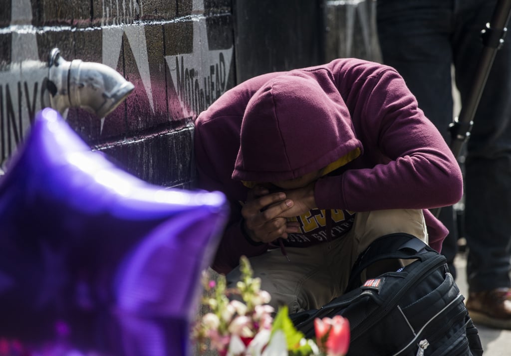 A fan grieved at the impromptu memorial outside First Avenue.