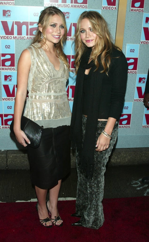 Twinning combo: At the 2002 MTV VMAs, the Olsens partied the night away in age-appropriate ensembles.

Ashley tempered her leather pencil skirt with an iridescent blouse and black sandals.
Mary-Kate stood out in printed velour pants.