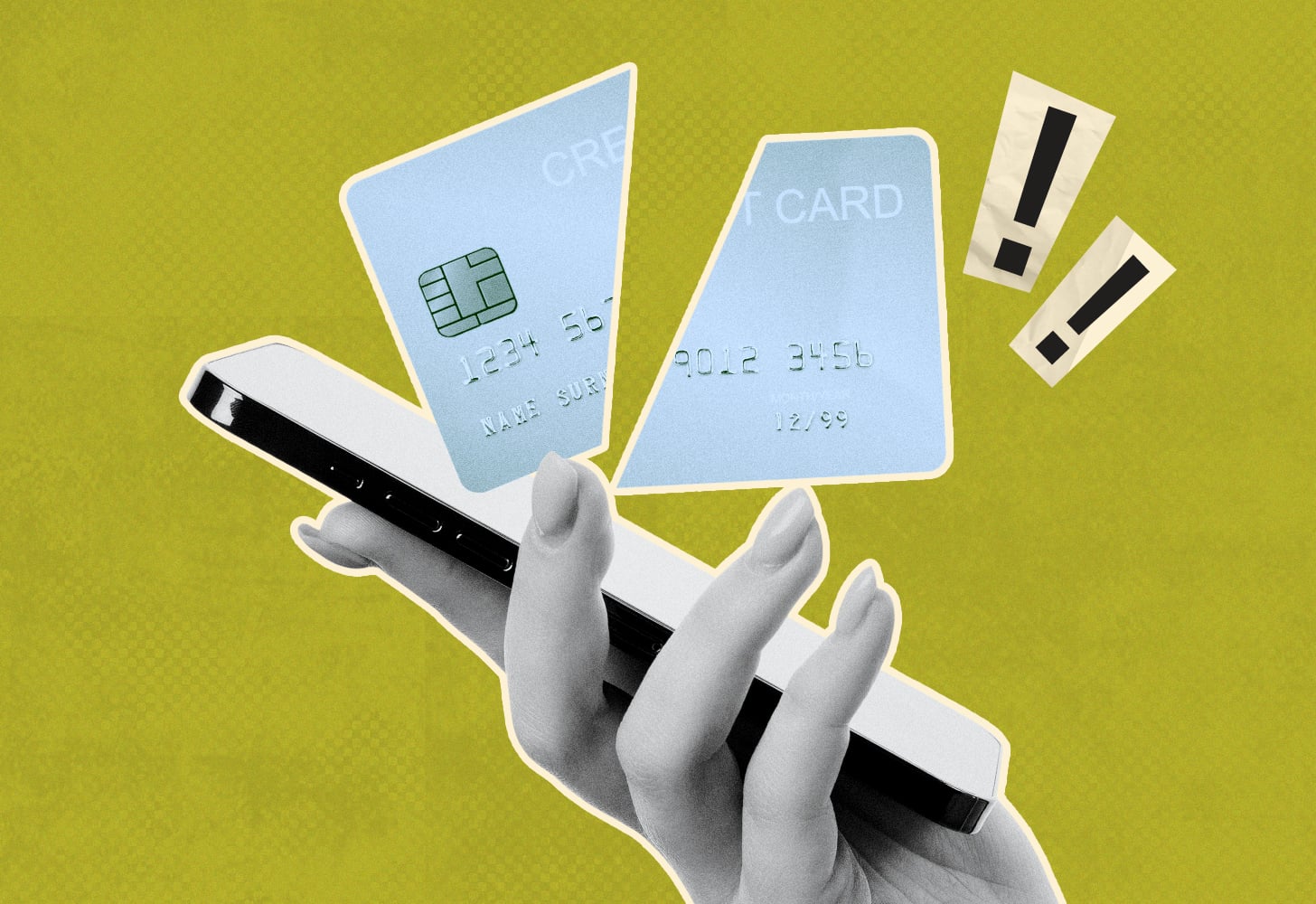 a person holding a smartphone and a cut credit card