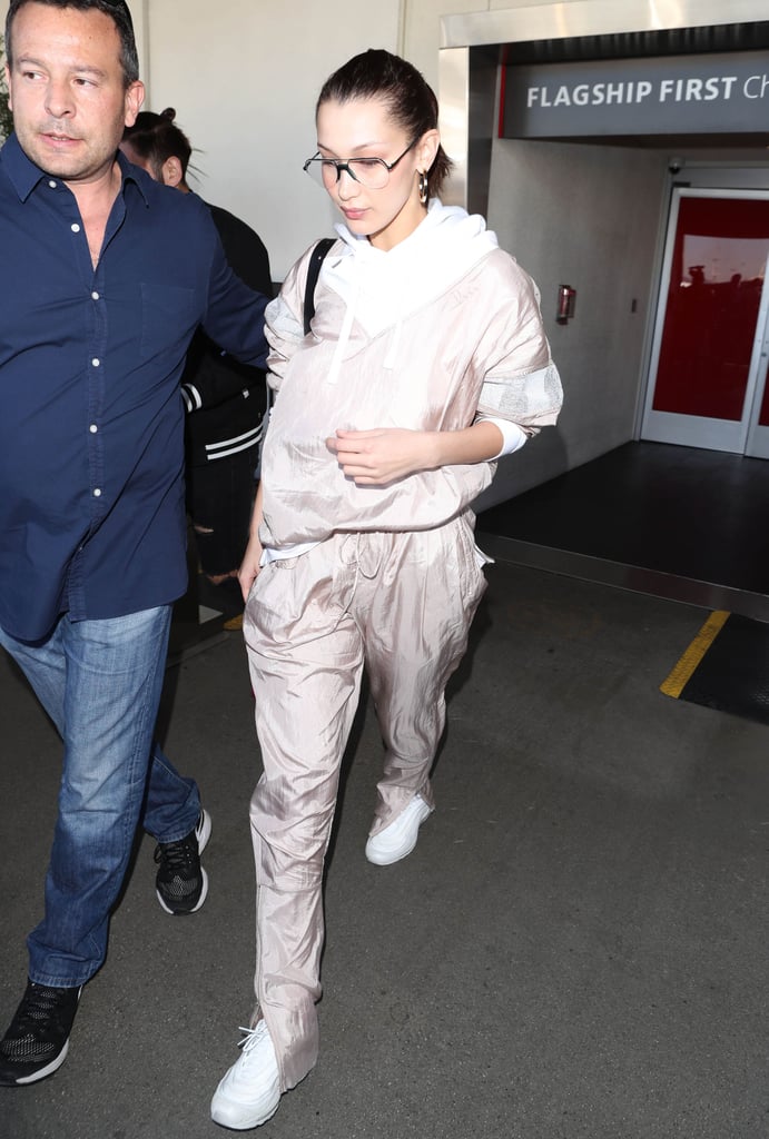 Wearing a casual tracksuit and white sneakers.