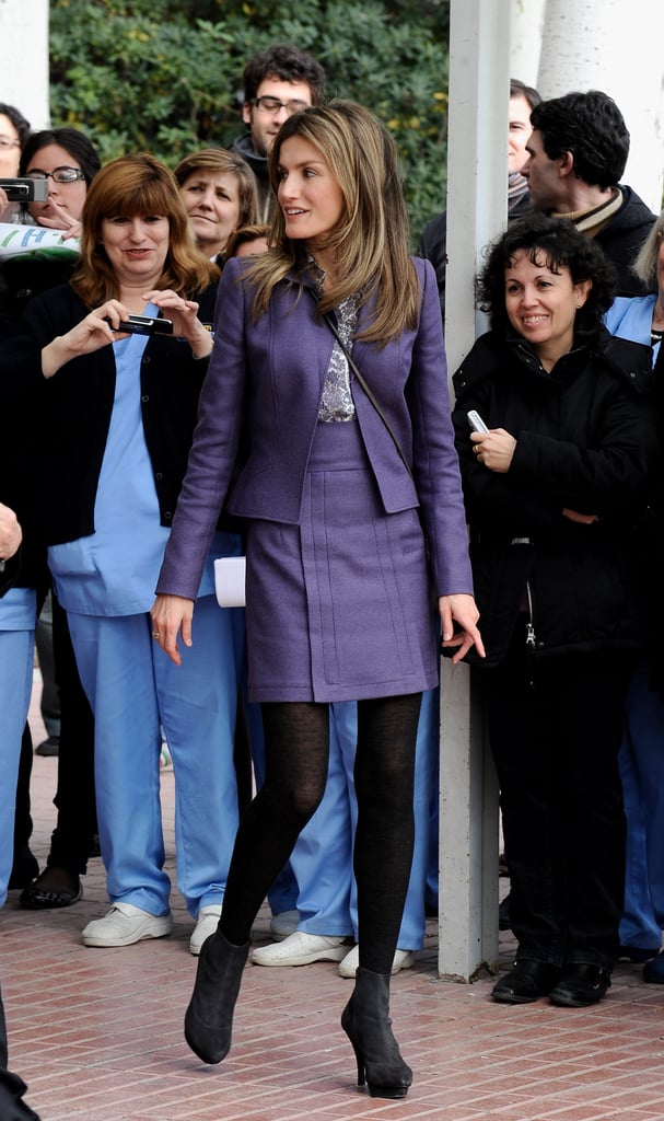 Queen Letizia wearing a purple suit set.