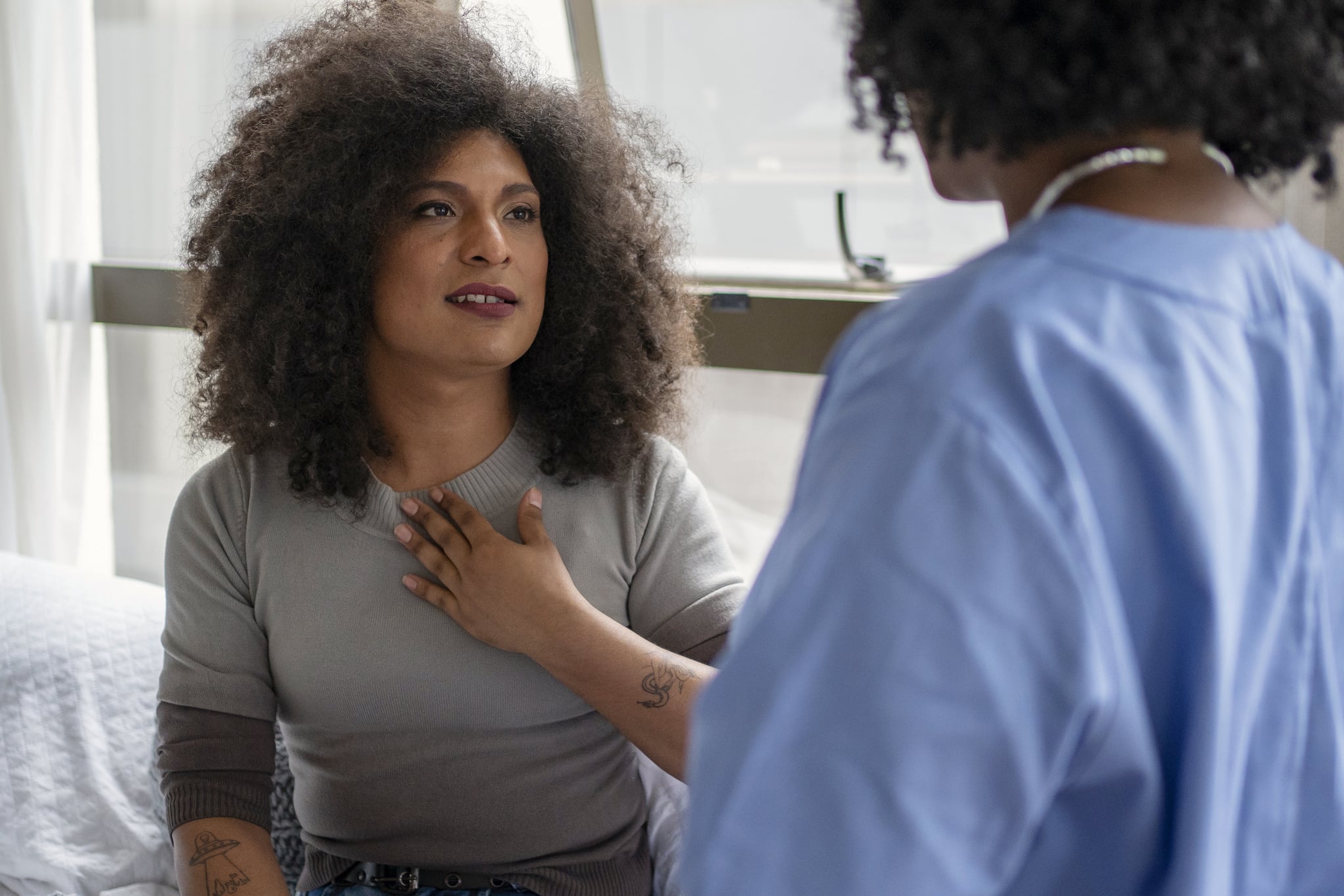 Nurse examining transgender woman at home