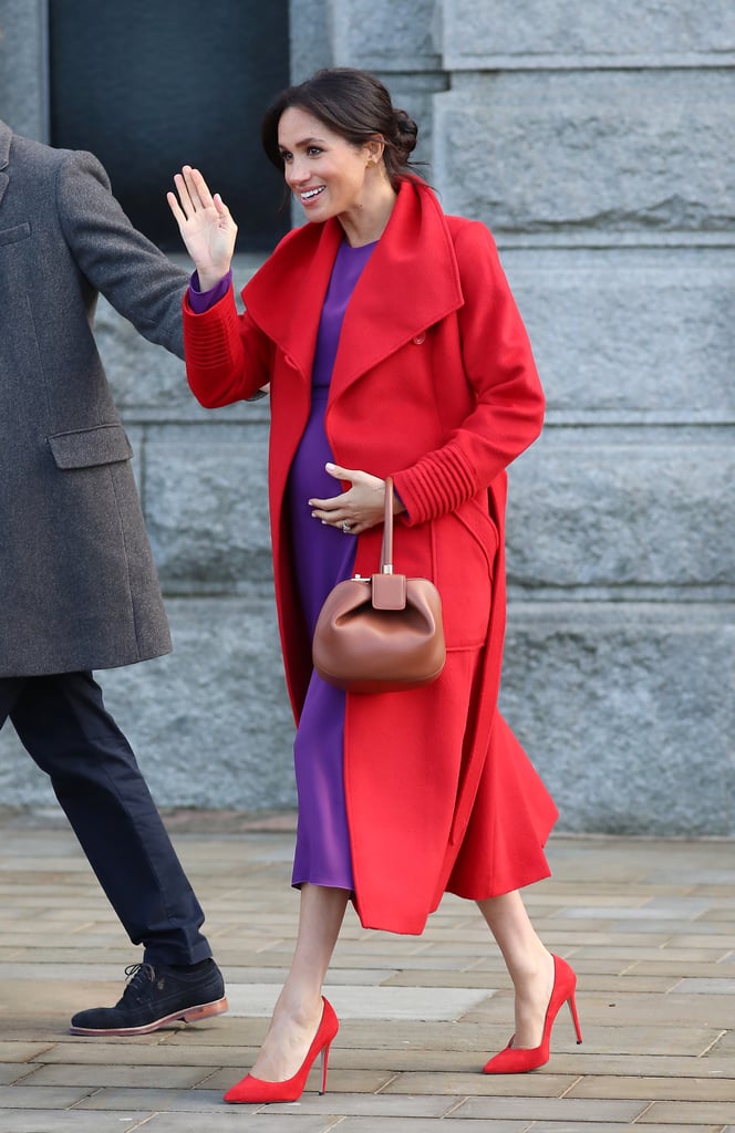 Meghan Markle mixed red and purple with ease, right down to her heels in this Aritzia dress and Sentaler coat.