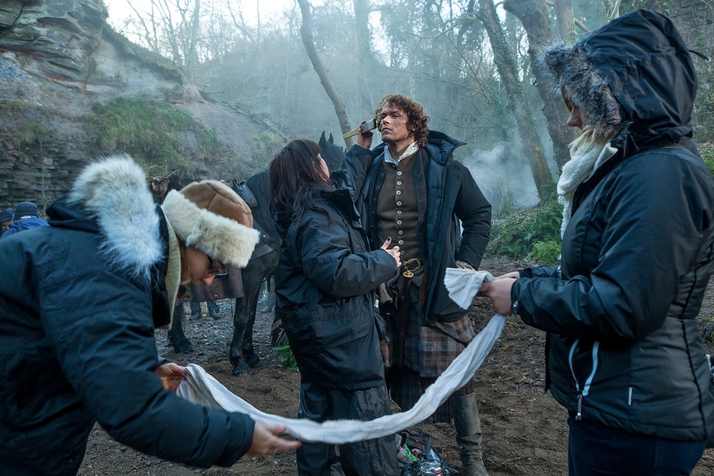 Heughan gets touched up between scenes.