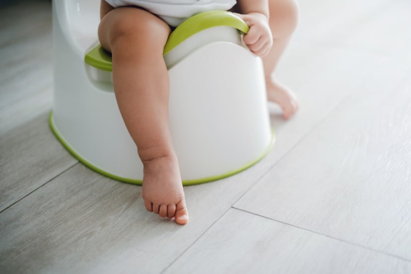 Close up of a toddler sitting on a potty chair on potty training